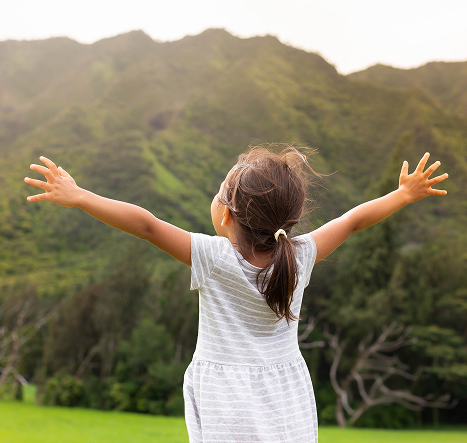 Young Girl outdoors with arms raised